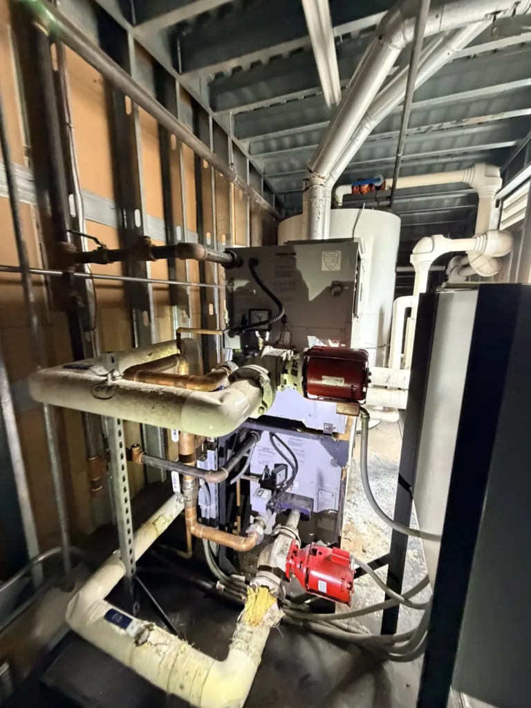 Commercial boiler burner and gas piping in a rooftop mechanical room