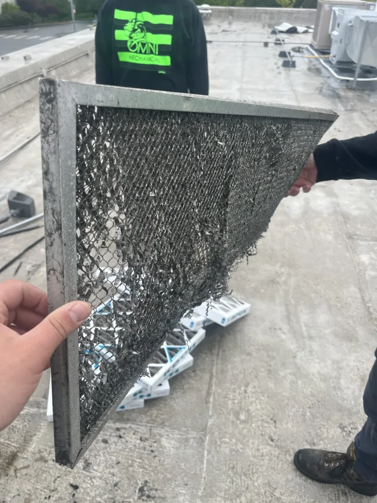 Loaded air filter pulled from a rooftop unit during maintenance