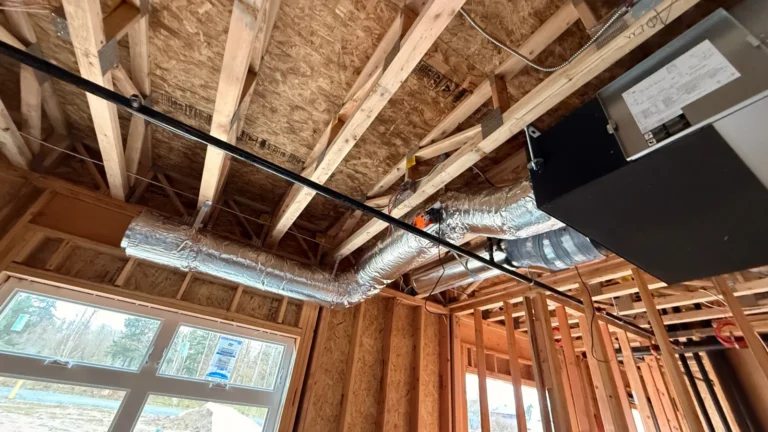 Ducted Daikin VRV indoor unit hung in the framing with supply duct and refrigerant lines