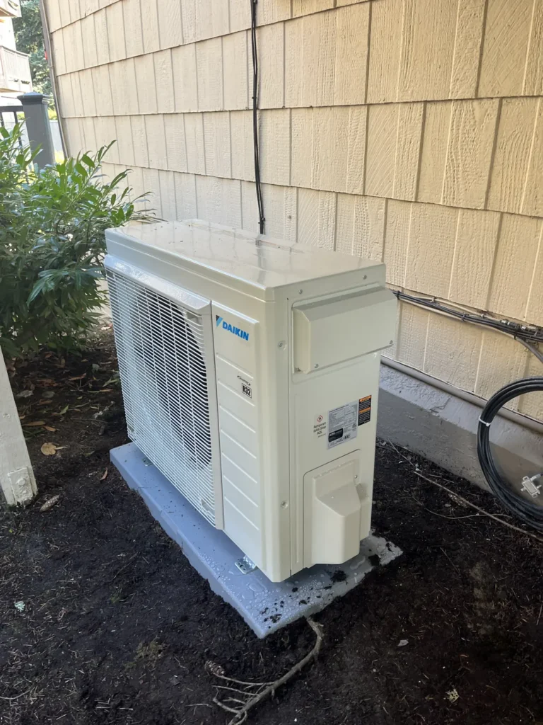 Daikin heat pump condenser installed on a pad beside a clubhouse in Redmond