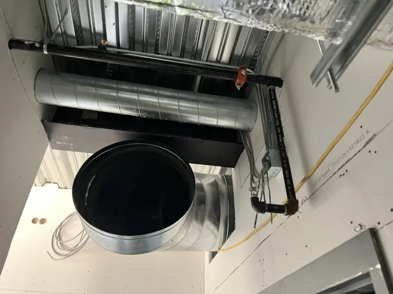 Ducted HVAC unit with round duct and condensate piping in a new building
