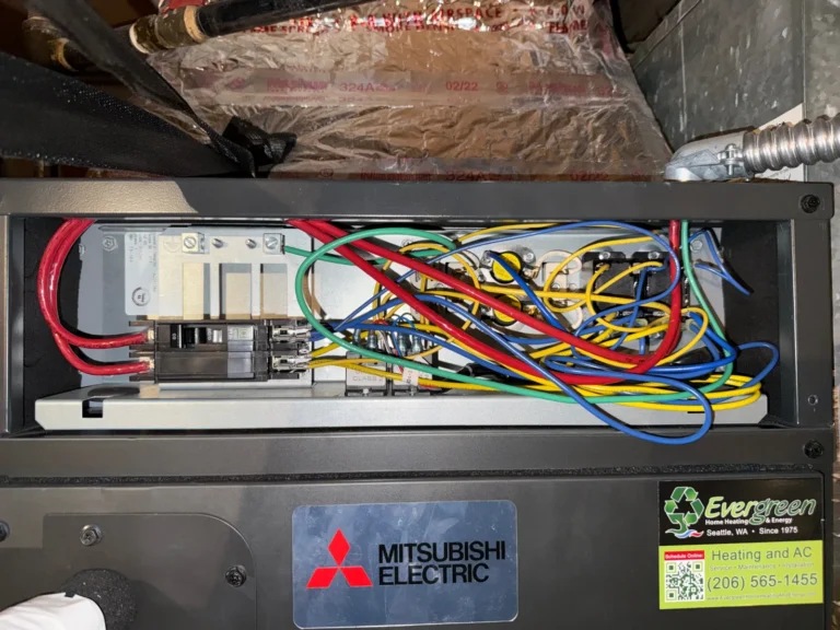 Control board inside a Mitsubishi heat pump unit during diagnostics