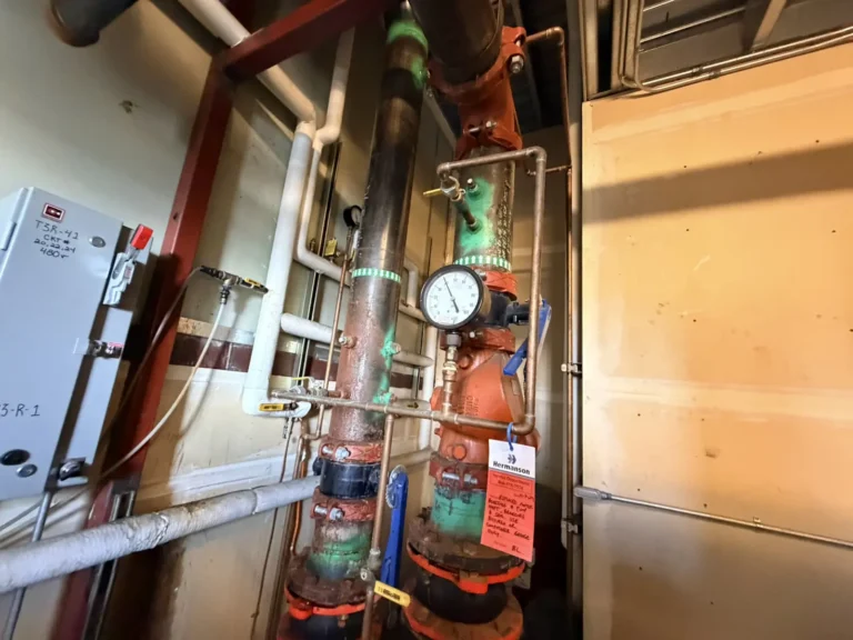 Hydronic piping risers, gauge and control panel in a mechanical room