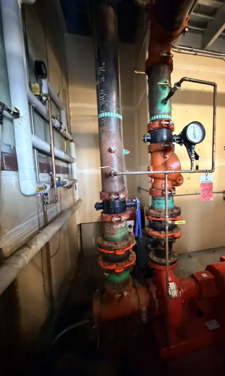 Hydronic pump and piping with pressure gauges in a mechanical room