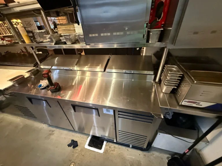 Refrigerated prep table line in a restaurant kitchen