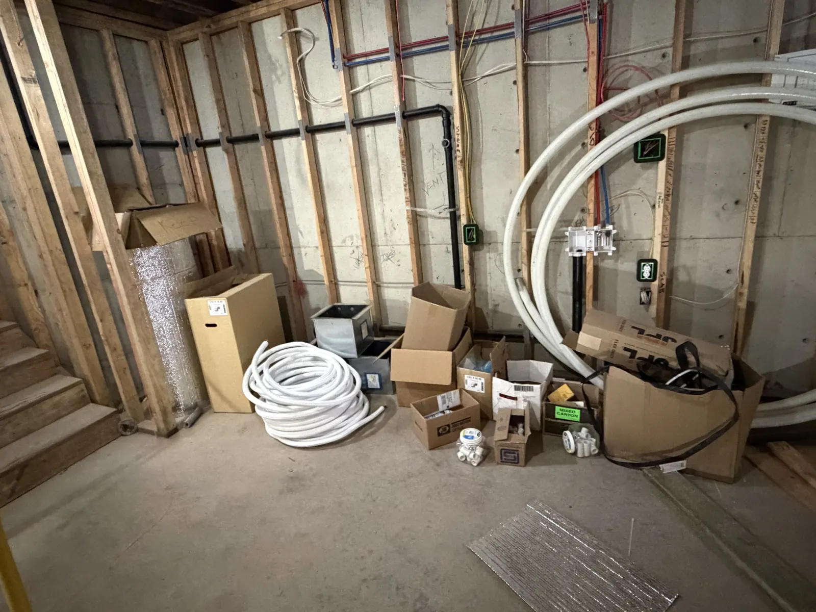 Line sets and materials staged for an HVAC rough-in