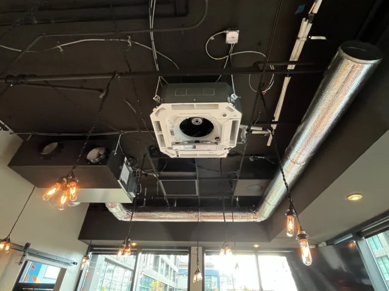 Four-way VRF ceiling cassette with a ducted unit behind it, downtown Seattle