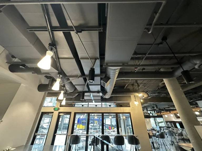 Exposed spiral ductwork over a restaurant dining room in Seattle