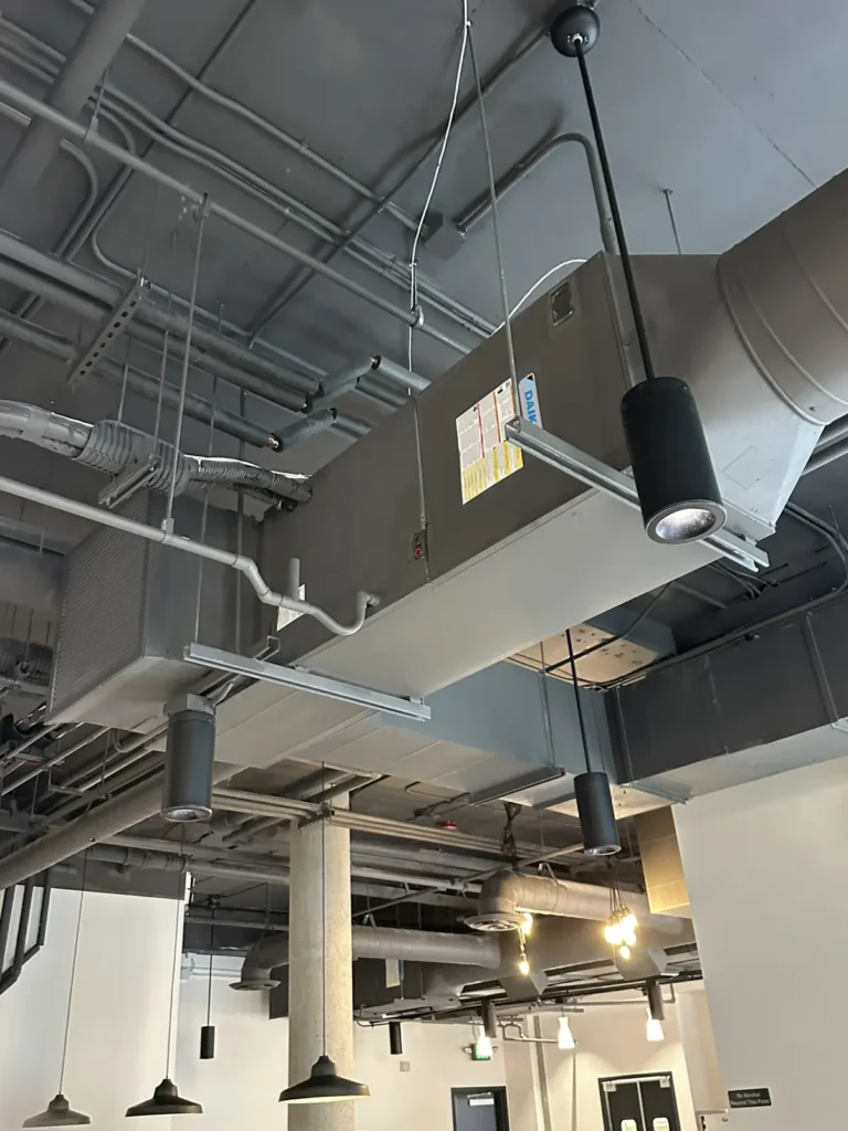 Spiral supply ductwork in an open restaurant ceiling
