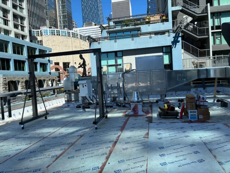 Gantry for resetting HVAC equipment on a new roof membrane above downtown Seattle