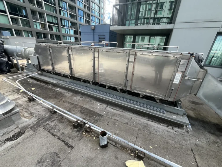 Stainless steel rooftop air handler on a downtown Seattle building