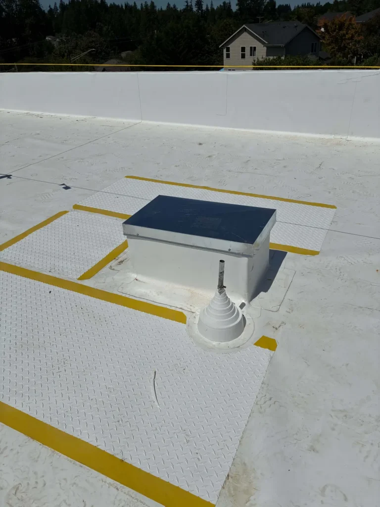 Rooftop HVAC curb on a new white commercial roof
