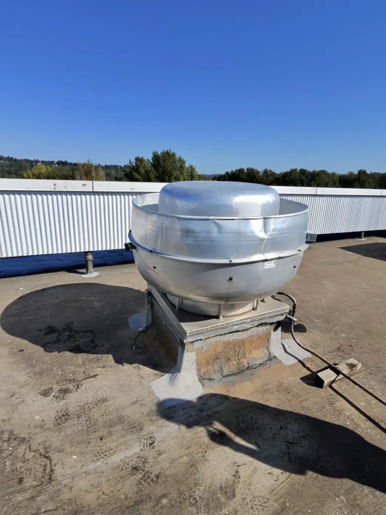Rooftop upblast exhaust fan on a commercial building