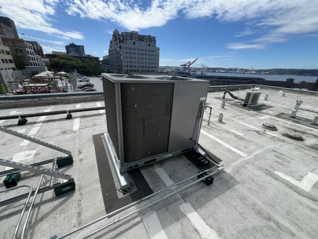 Rooftop HVAC unit on a downtown Seattle high-rise with Elliott Bay in the background