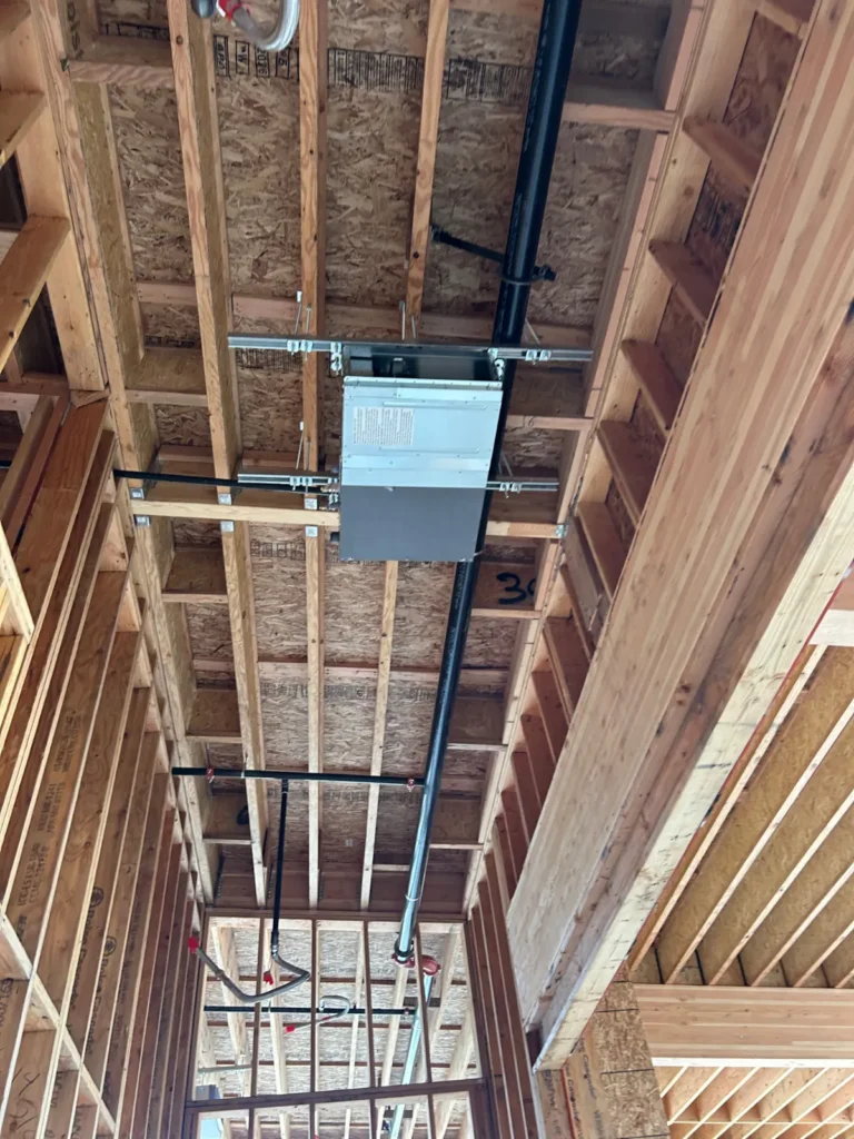 VRF fan coil hung in the framing with refrigerant piping at a Bonney Lake clubhouse