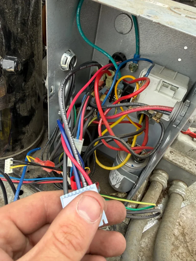 Technician repairing control wiring on a walk-in cooler